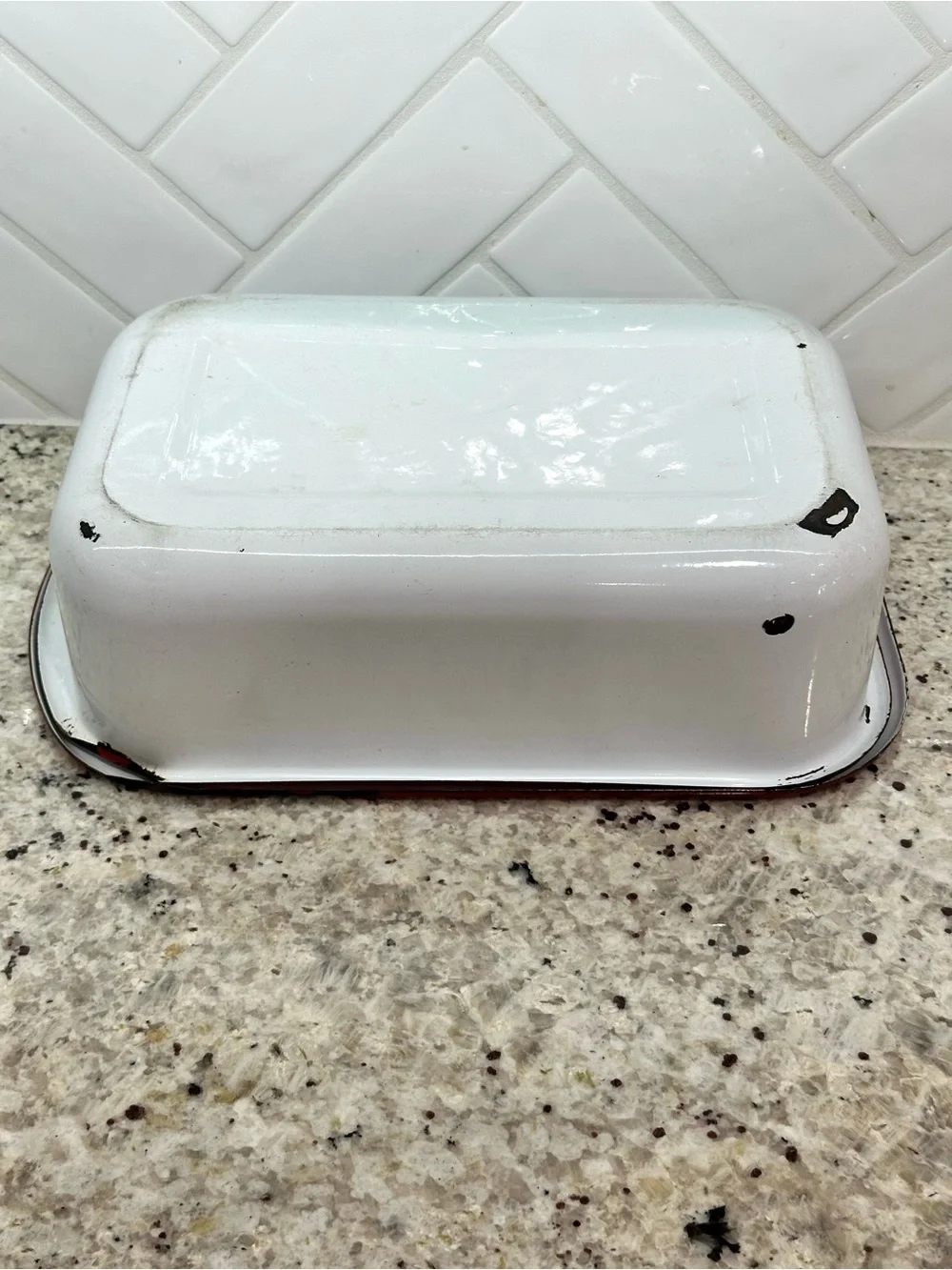 Vintage white enamel pan with red trim